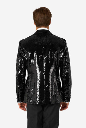 Back view of man wearing a black sequin blazer with satin collar, showing the reflective sequins across the back.