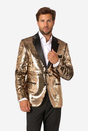 Man wearing a shiny gold sequin blazer with black satin lapels and black trousers, standing facing forward.