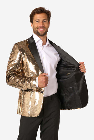 Man smiling while opening the gold sequin blazer to reveal a plain black inner lining.
