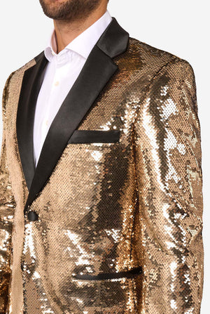 Close-up of the gold sequin blazer showing the black satin lapel, chest pocket, and part of the button closure.