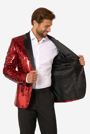 Smiling man holding open the inside of a red sequin blazer to show the black satin lining.