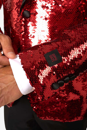 Close-up of the red sequin blazer’s sleeve with black buttons and OppoSuits label detail.