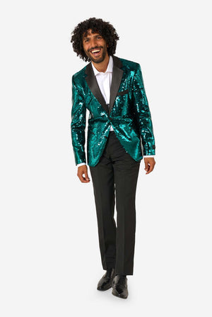Man smiling and leaning forward while wearing a teal sequin blazer with black satin lapel, paired with black dress pants and shoes.