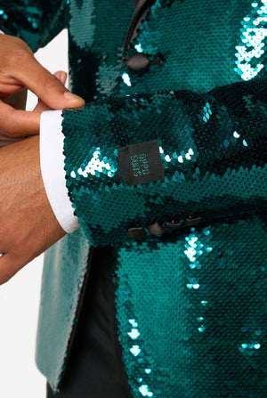 Close-up of a teal sequin blazer sleeve with OppoSuits label stitched above the cuff and black button details.