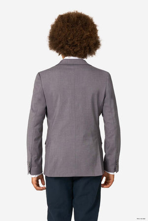 Back view of a child wearing a light grey blazer and dark trousers against a white background.