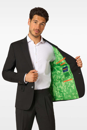 A man in a black blazer showing the inside lining printed with green pixelated Minecraft-style graphics.