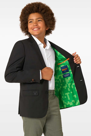 A child smiling while showing the bright green pixel-patterned inner lining of a black blazer.