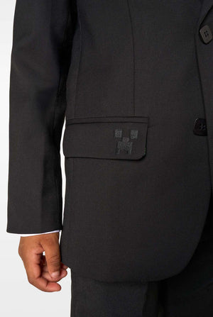 Close-up of the blazer pocket with a small pixel-style black embroidered icon.