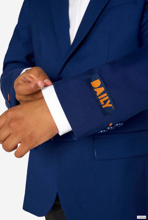 Close-up of a blue blazer sleeve showing an orange “DAILY” label and button details.