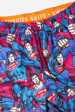 Men's Superman-themed swim shorts featuring a bold comic book design with multiple action poses of the Man of Steel. Perfect for superhero fans looking to make a splash. Close up.