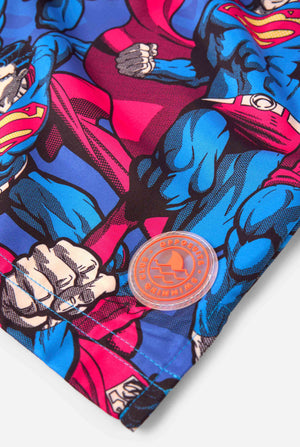 Men's Superman-themed swim shorts featuring a bold comic book design with multiple action poses of the Man of Steel. Perfect for superhero fans looking to make a splash. Close up patch.
