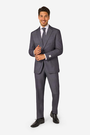 A man is wearing a stylish charcoal colored grey suit with a white dress shirt, looking confidently. Perfect formal outfit for men's special occasions, weddings, and parties. Full body image.