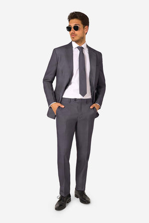 A man is wearing a stylish charcoal colored grey suit with a white dress shirt, looking confidently. Perfect formal outfit for men's special occasions, weddings, and parties.