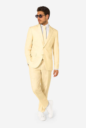Elegant men's suit in a soft pastel yellow shade, perfect for weddings, summer events, and formal occasions. This stylish tailored suit features a slim fit design, notch lapels, and a matching tie for a sophisticated look. Ideal for modern gentlemen looking to make a statement with a light-colored pastel suit. Man wearing sunglasses.