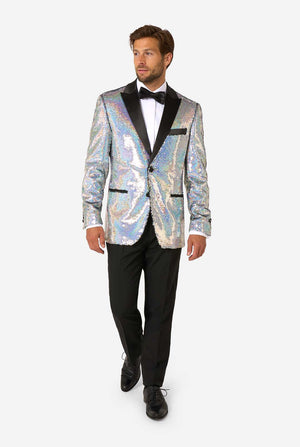 Man in a holographic silver sequin tuxedo with black satin lapels, white shirt, and black bow tie, walking forward in black trousers and dress shoes