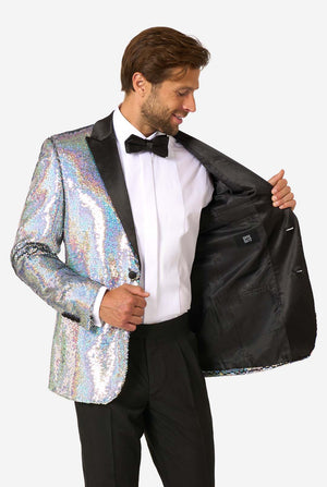 Man smiling while holding open a holographic silver sequin tuxedo jacket to reveal a solid black interior lining with an OppoSuits label.