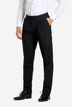 Close-up of black tuxedo trousers paired with a white dress shirt and black dress shoes.
