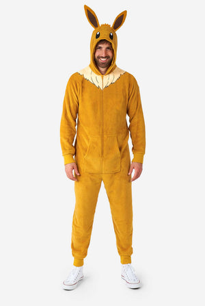 A man is wearing an adorable Eevee onesie, modeled after the beloved Pokémon character. This adult unisex onesie is designed in a warm brown color, resembling Eevee’s fur, and features a fluffy beige collar mimicking Eevee’s mane. The hood includes Eevee's signature large brown ears, big black eyes. The onesie has a front zipper closure and convenient pockets at the front, offering both comfort and ease of wear. Perfect for Pokémon fans, this cozy fleece onesie is ideal for lounging or cosplay.