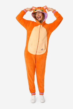 A women is wearing an orange adult onesie designed as a red cat onesie. The onesie features a hood resembling a cat's head, and cat details, perfect for cozy lounging or costume parties. She has her hood on her head. Full body image.