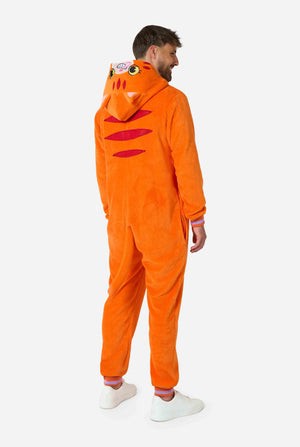 A smiling man is wearing an orange adult onesie designed as a red cat onesie. The onesie features a hood resembling a cat's head, and cat details, perfect for cozy lounging or costume parties. Full body image from the side/back.