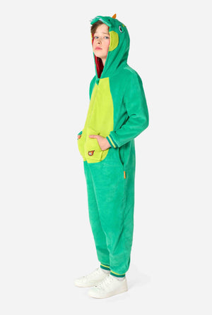 A kid is wearing a green dinosaur kids onesie featuring playful hood details and cozy, soft material, perfect for lounging or costume events.  Full body image.