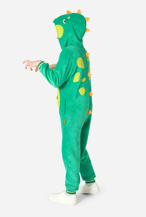 A kid is wearing a green dinosaur kids onesie featuring playful hood details and cozy, soft material, perfect for lounging or costume events. Side view image.