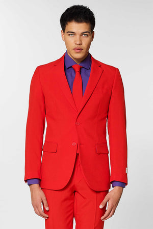 Video of man wearing Red Devil, red men's suit, showing suit like a model. Suit consists of blazer, pant and tie.