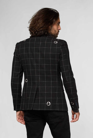 Black casual blazer with white grid pattern worn by man sitting on stool