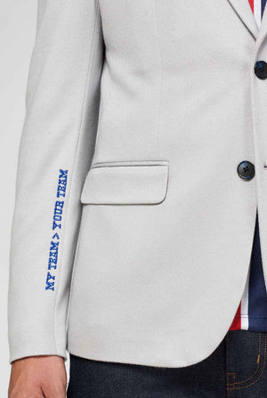 Grey sportswear casual blazer with sports patches worn by man