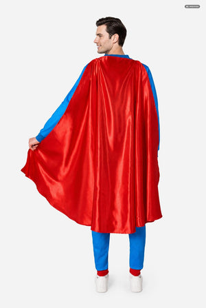 Person wearing a red superhero cape with blue trim on a white background