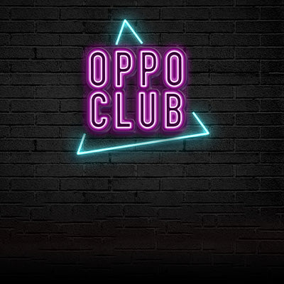 Image of the Oppo Club logo. Neon letters in front of a brick wall