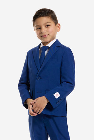 Young boy wearing a blue kids suit on a white background