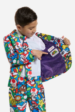 Image of kid wearing a Super Mario all over print suit, consisting of blazer, pants and tie. Main color is blue, but there is also yellow, red and white. Showing inside of the blazer.