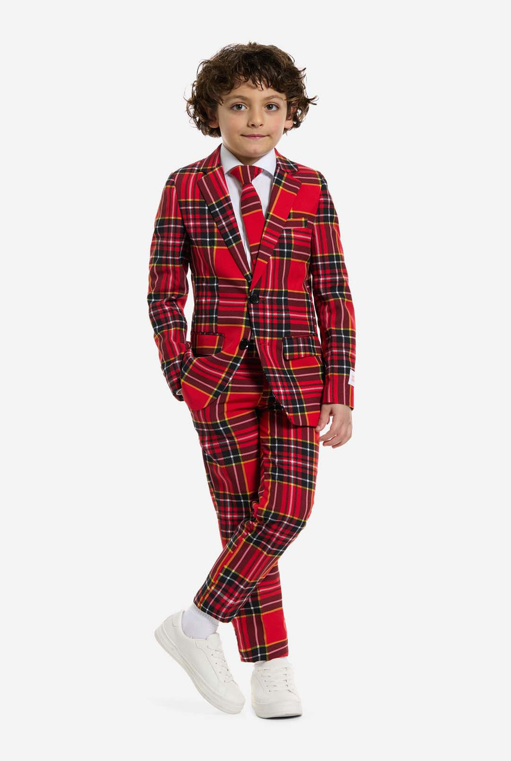 Child wearing a red plaid Christmas suit on a white background