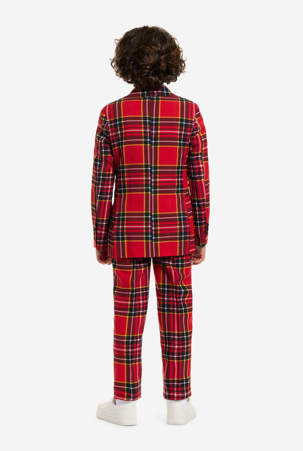 Person wearing a red plaid Christmas outfit on a white background, view from the back.