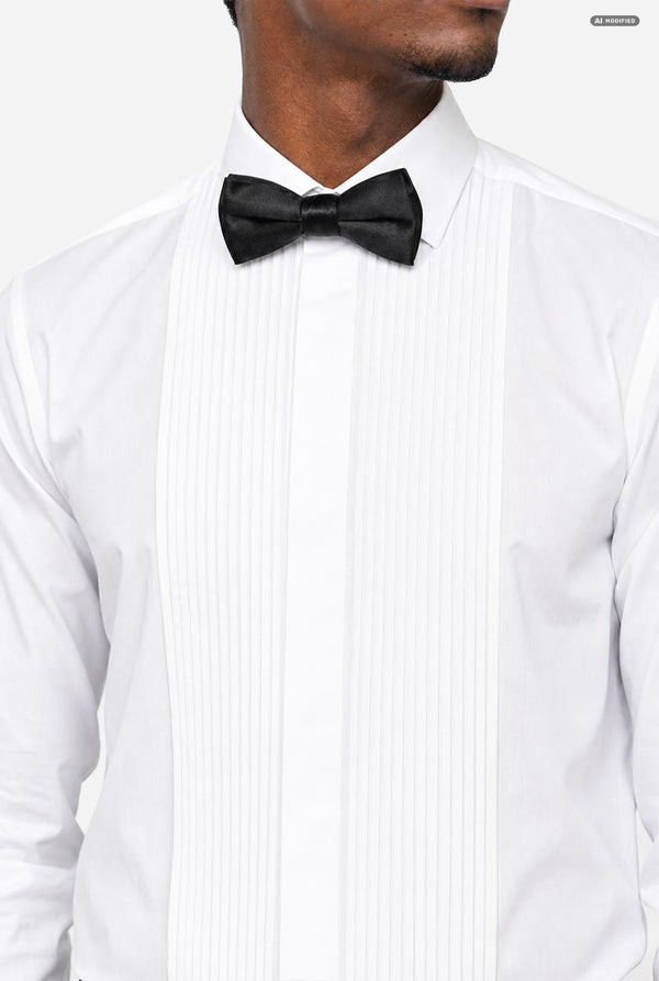A close-up of a man wearing a white tuxedo shirt with a black bow tie, cropped from the lower face to the chest against a light gray background.