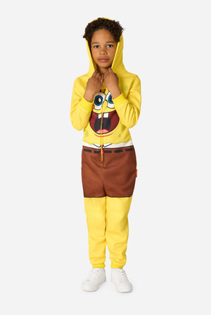 Child wearing a yellow SpongeBob onesie with a white background, holding hood.