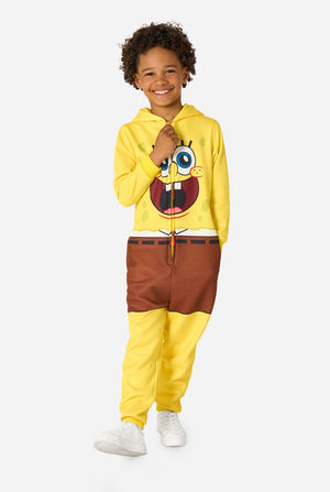 Child wearing a yellow SpongeBob onesie with a white background, full body image.