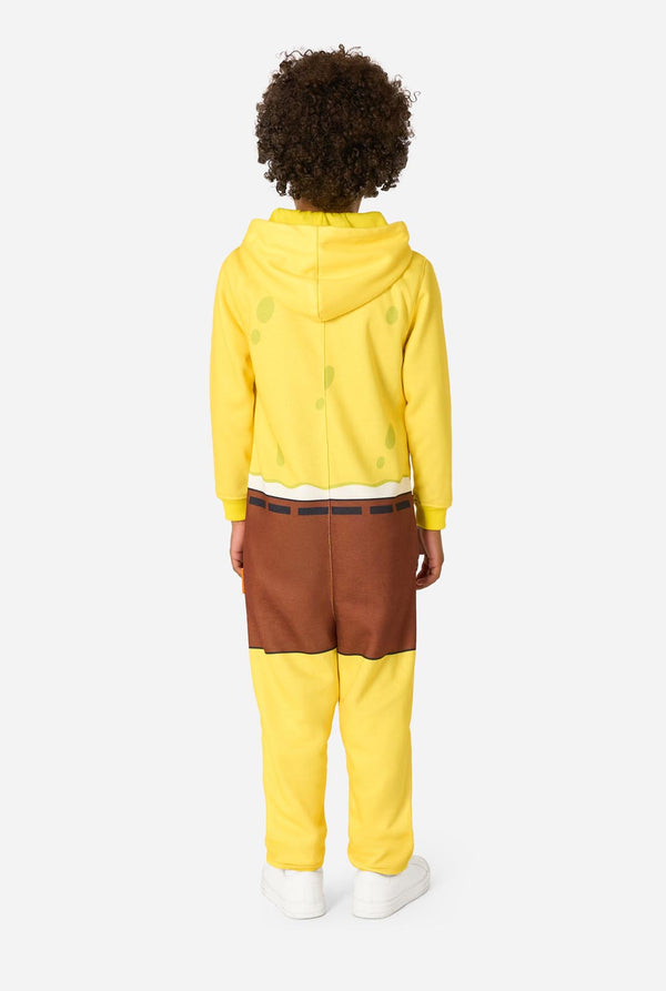 Child wearing a yellow SpongeBob onesie with a white background, viwe from the back