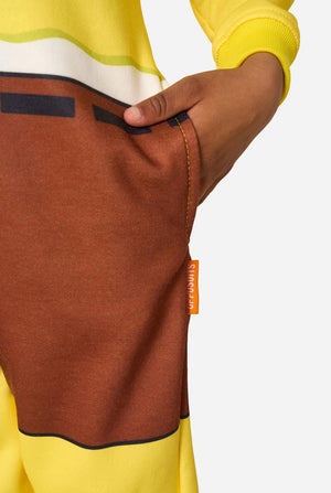 Child wearing a yellow SpongeBob onesie with a white background, pocket close-up.