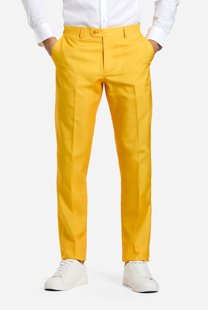 Man wearing yellow pants, part of the OppoSuits ELF men's suit, white shirt and white sneakers. Waist down image.