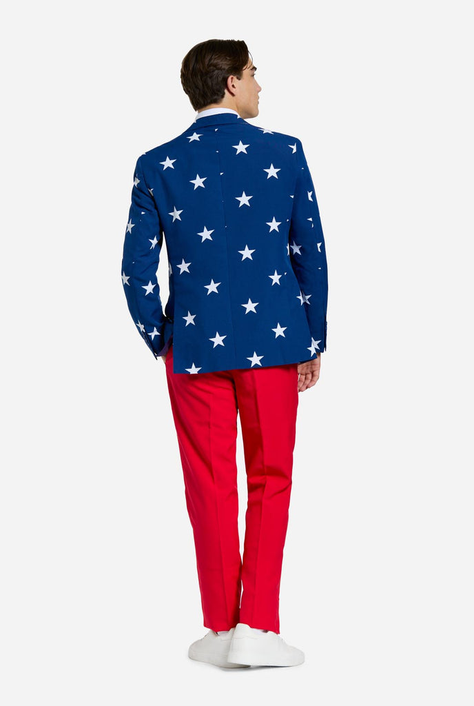 Man wearing red and blue USA themed suit for 4th of July, view from the back