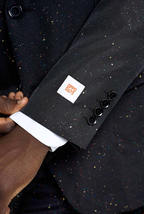 Image of a man wearing an OppoSuits Glitzy Glitter men's suit with glitters and white men's shirt. Suit consist of pants, jacket and tie. Sleeve close-up.