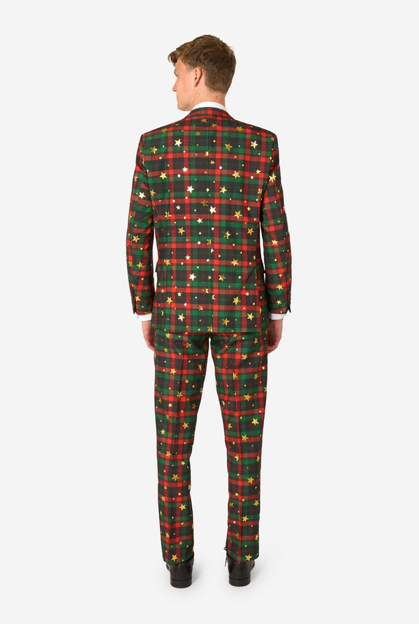 Back view of man wearing a red and green tartan plaid suit with gold star and dot accents.