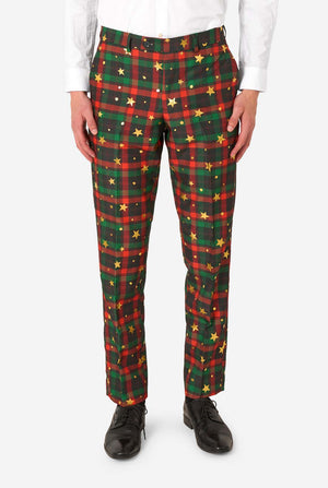 Close-up of tartan plaid suit trousers with gold star and dot accents, paired with black dress shoes.