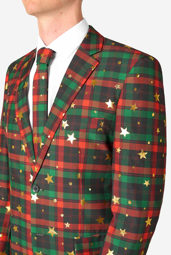 Close-up of upper body in tartan plaid suit with gold stars and dots, showing notch lapel and matching tie.