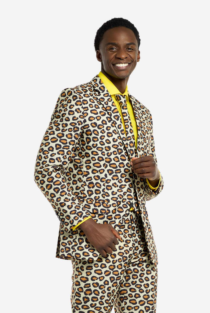 Image of a man wearing an OppoSuits The jag men's suit with panther print and yellow men's shirt. Suit consist of pants, jacket and tie. Man smiling in camera.