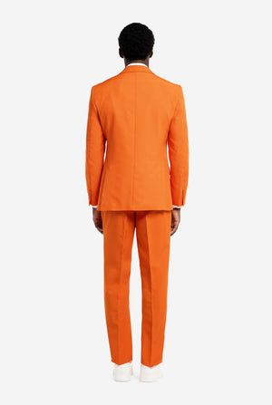 Person wearing an orange suit on a white background