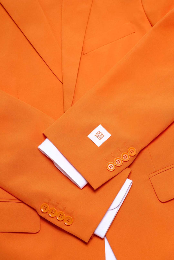 Close-up of an orange suit with a white shirt underneath