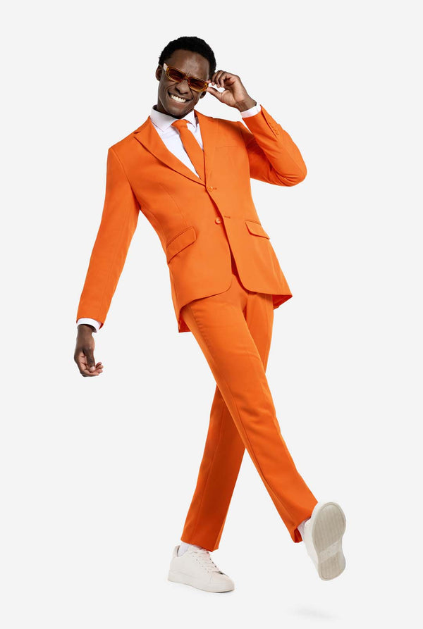 Man wearing an orange suit with white shoes on a white background